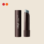 OBgE Mood Change Lip Balm in its dark brown tube with the balm exposed