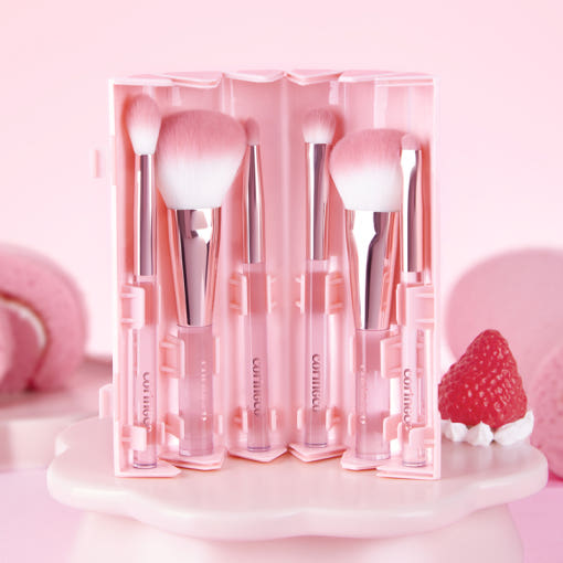 CORINGCO Pink Roll Brush Set 6P with six pink makeup brushes in a roll-up case