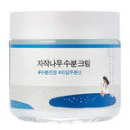 Hydrating blue cream jar with Korean text, set against a glossy light blue background.
