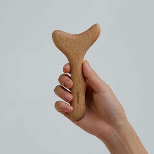 SENNOK Multi Bbul Guasha beechwood massage tool held in a hand