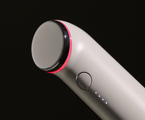 THOME The Glow Signature dual-frequency ultrasound facial beauty device on its charging stand